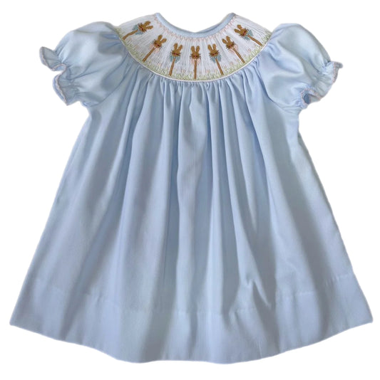Light blue smocked bishop dress with pink and white Easter bunny's by Lulu Bebe. 