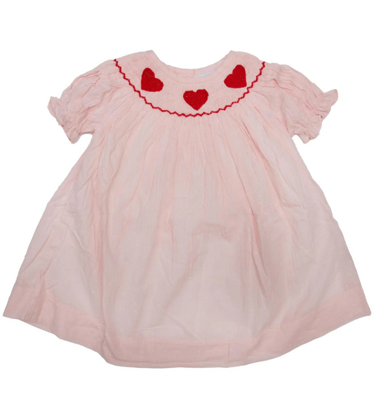 Girls pink Swiss dot Valentines Day dress with red hearts smocked on collar by Ann + Reeves. 