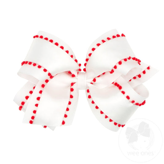 White bow with red pom pom's by Wee One's.