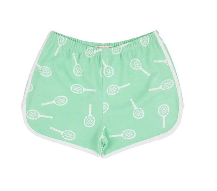 Green shorts with a tennis racquet print by The Beaufort Bonnet Company with white piping. 