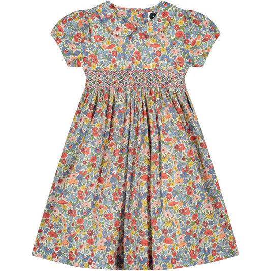 Lara Liberty Print Girls Smocked Dress by Question Everything features a soft floral print pattern and smocking. 