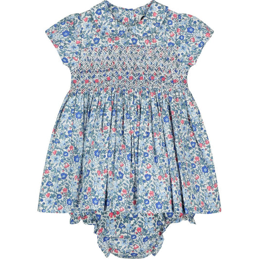 Agnes smocked baby dress by Question Everything hand smocked baby dress in a blue floral print with matching bloomer. Purchase at Houston Children's Boutique. Little Cottontail.